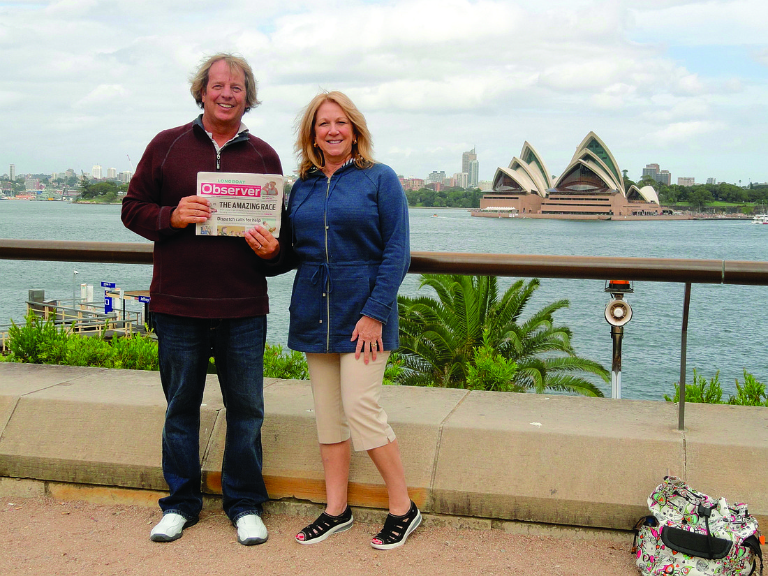 MUSICAL MOMENT. Andy and Lisa Weiland catch up on their Longboat Observer news in front of the Sydney Opera House in Australia.