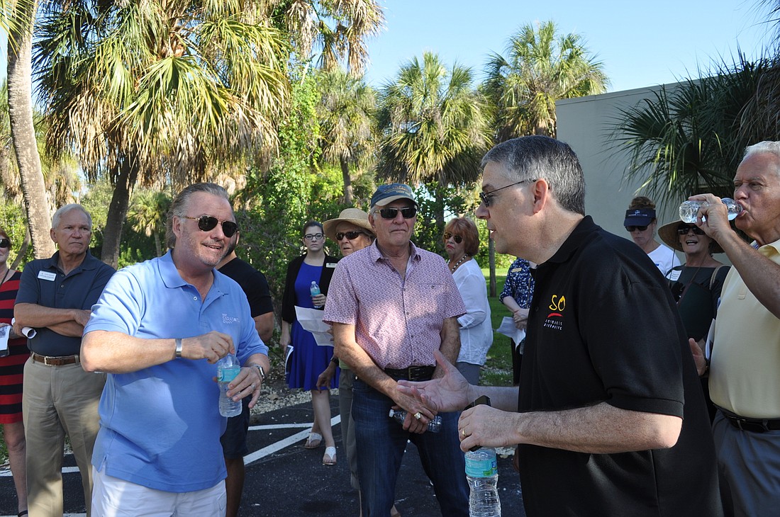 Bayfront 20:20 leader Michael Klauber talks with stakeholders during a walk along Sarasota Bay.