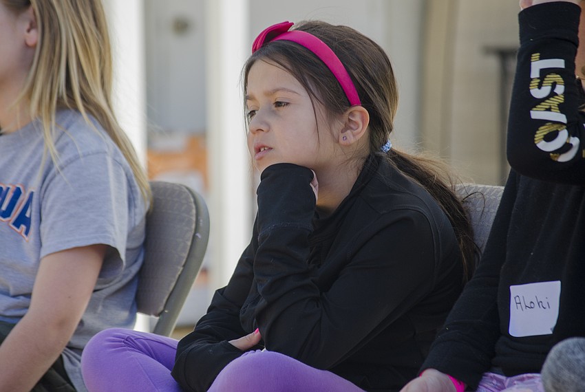 Olivia Schaedler-Luera listens to the hander's presentations on each of the animals.