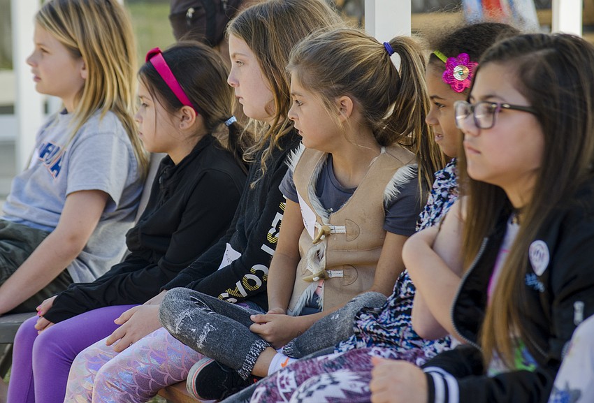 Children sat on a bench and watched presentations on the animals.