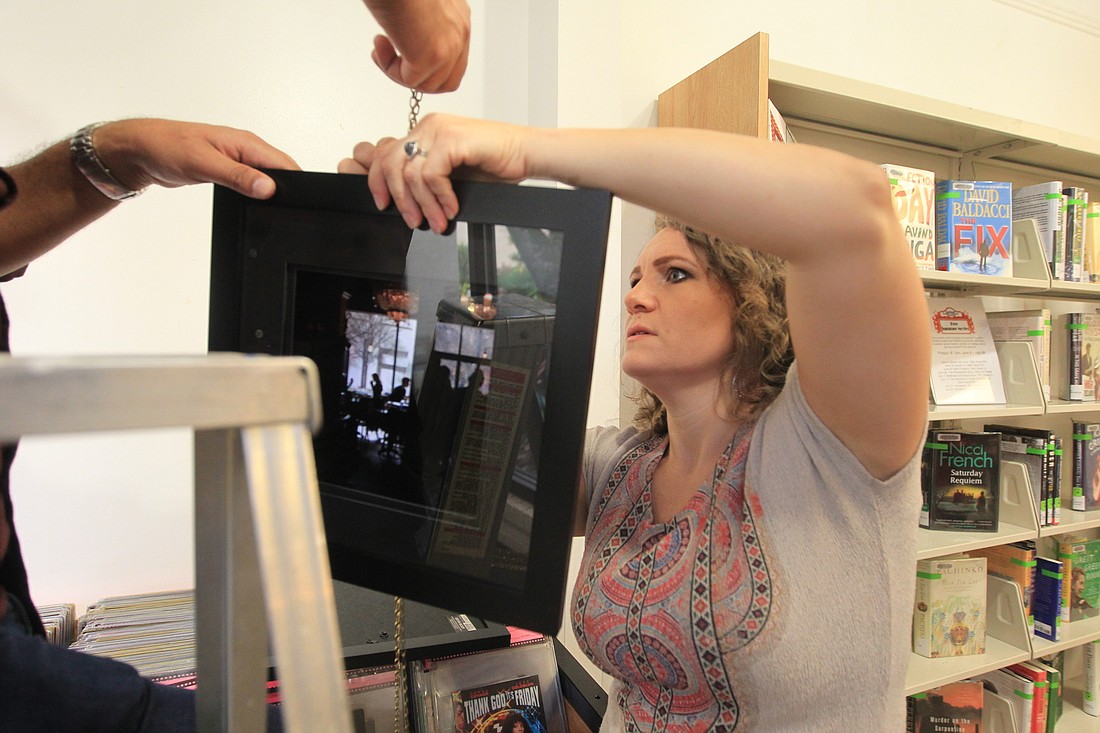 Veronica Diaz works on getting one of her pieces set up as she prepares her show.