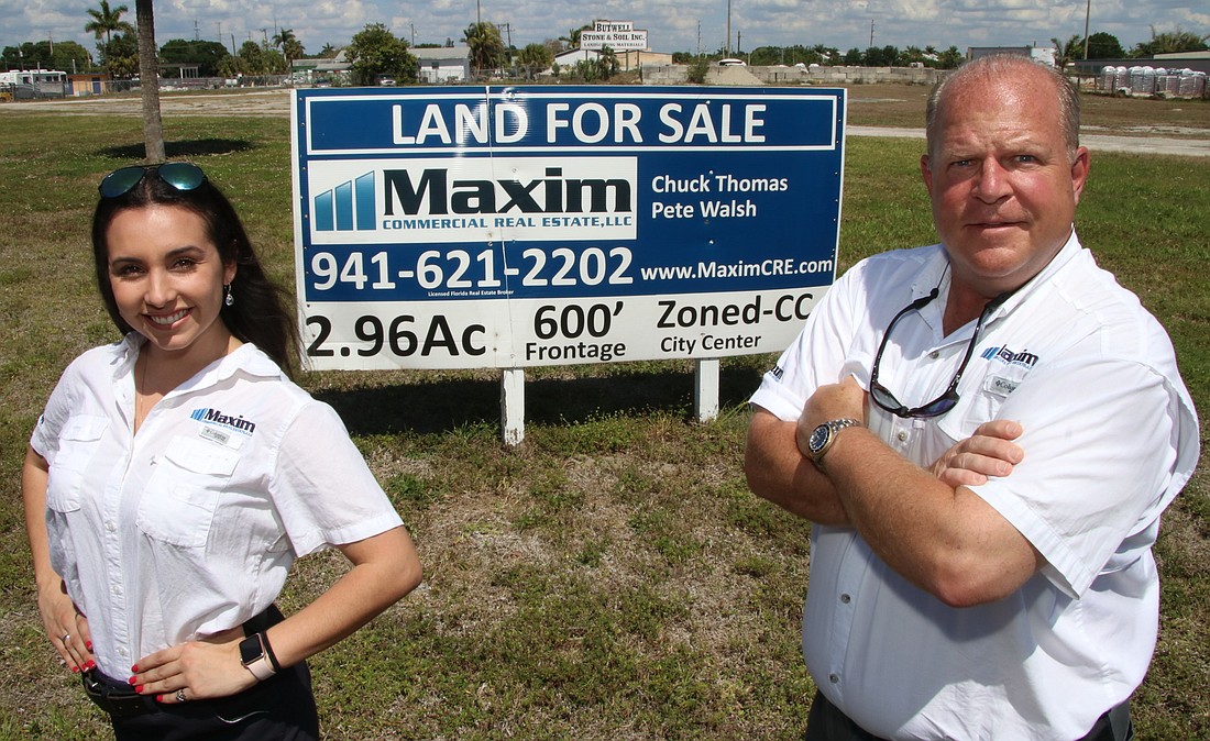 Maxim Commercial Real Estate Marketing Director Margeaux Vallee and Principal and Broker Chuck Thomas in front of one of the Charlotte County properties the firm has listed for sale.