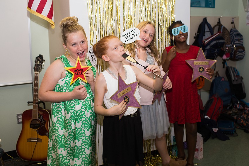Students pose for a photo with props.