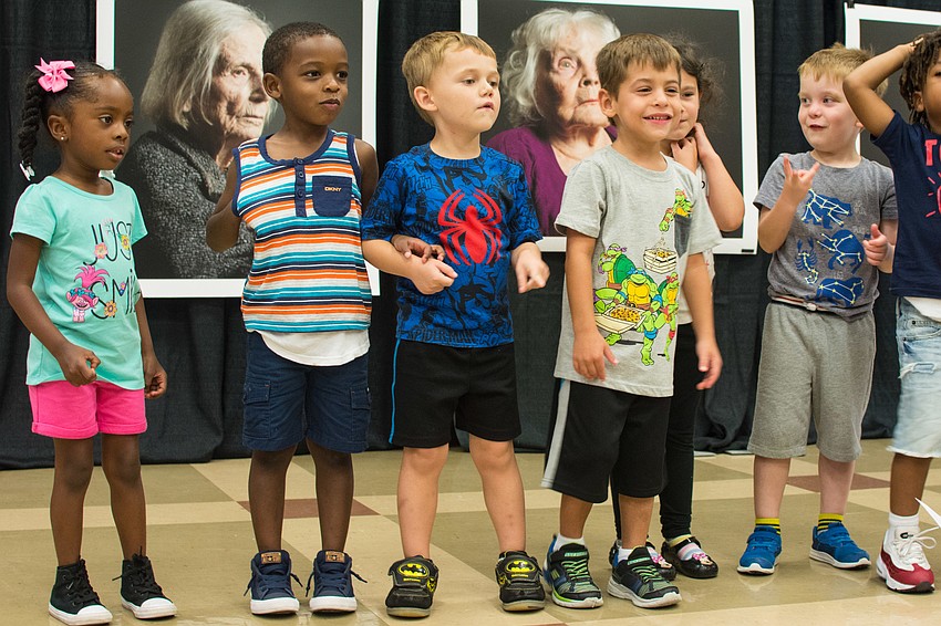 Students from the Pines of Sarasota's Child Care & Learning Center perform songs for the Pines centenarians.