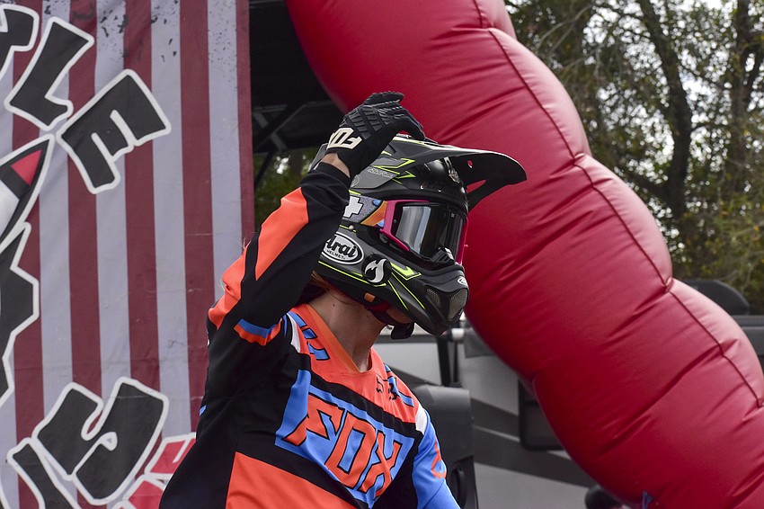 Austin Drummond pumps up the crowd as he rides past.