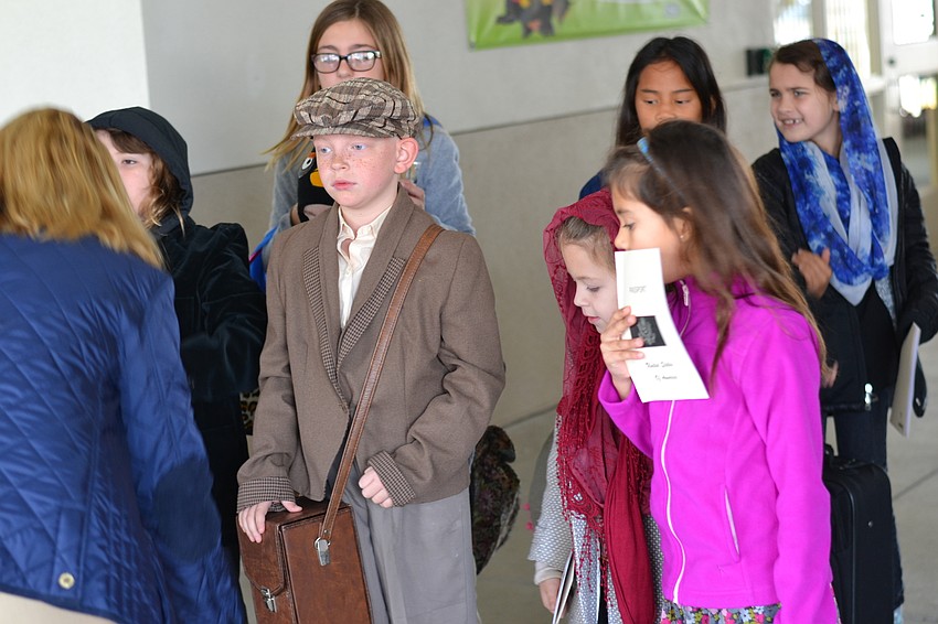 Students receive instructions upon arriving at Ellis Island.