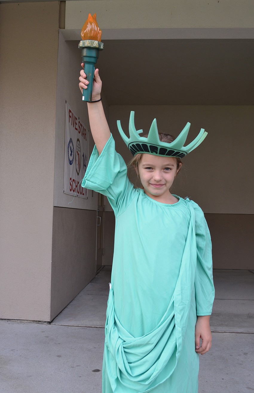 Ryelee Lococo dressed as the statue of liberty to signal to passengers that they had arrived at Ellis Island.