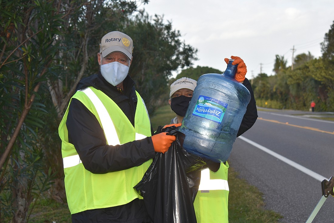 Jay Sparr and Liz Sparr found a water jug during a roadside Rotary cleanup. File photo.