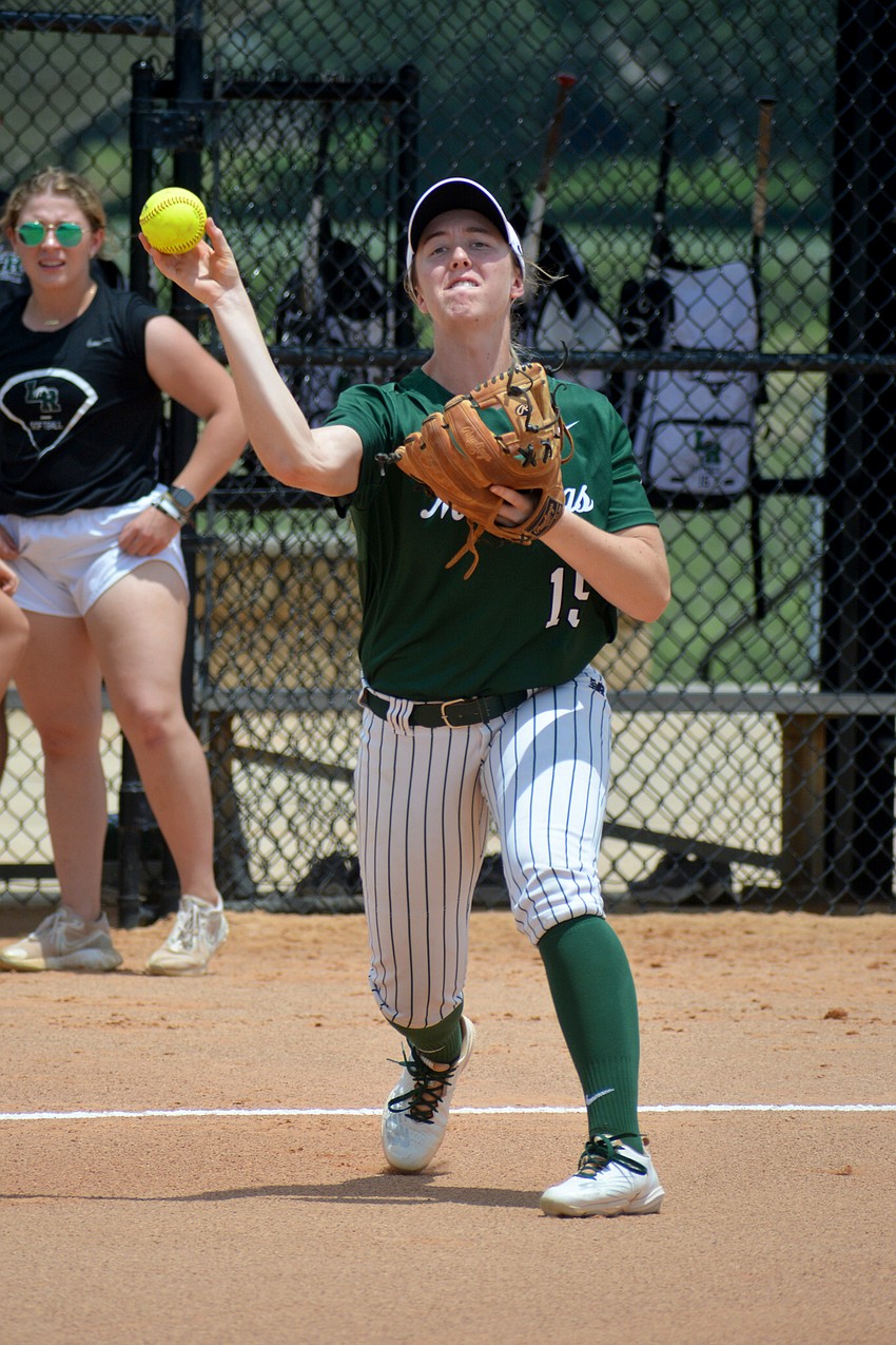 Lakewood Ranch junior Amanda Lee throws to first base while waring up before the Mustangs' 11-3 win over Western High.