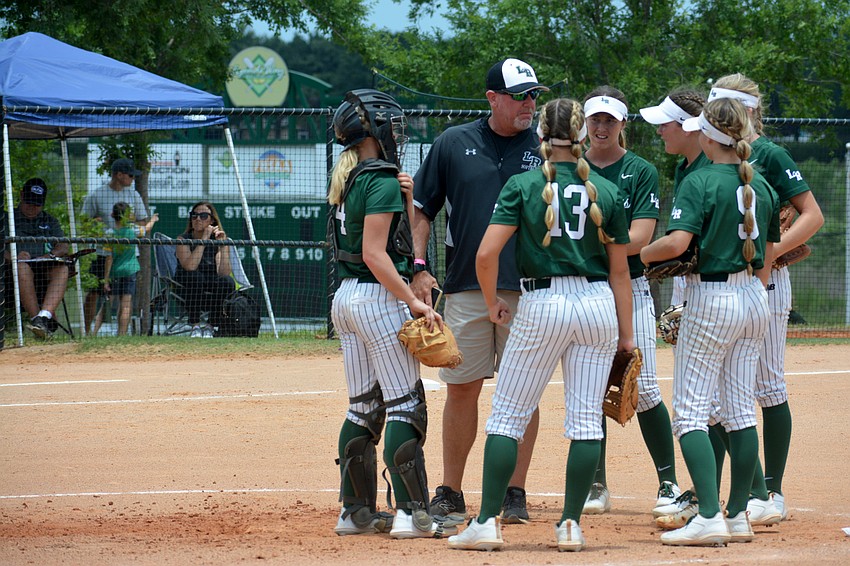 Mustangs Head Coach T.J. Goelz talks with his team during a mound visit against Western High.