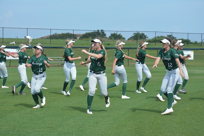The Mustangs warm up following a rain and lightning delay in their game against Western High.