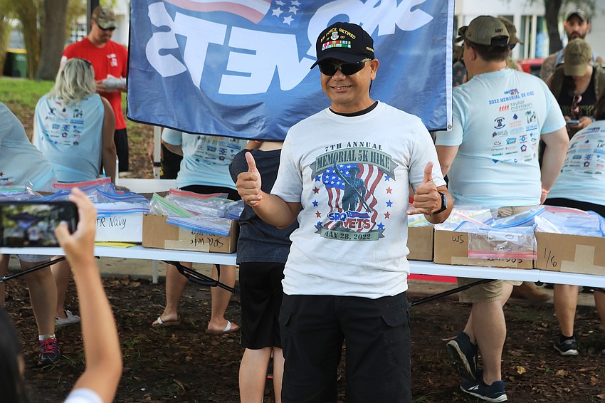 Nathan Negosa takes photos with his family.