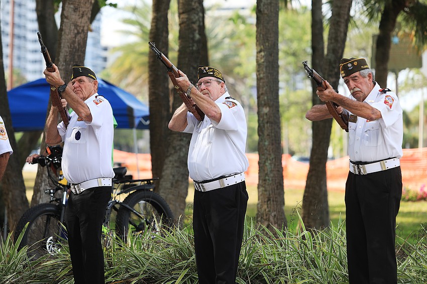Members of VFW 3233 fire guns in tribute.