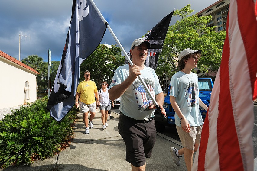 Veterans and civilians alike march through downtown Sarasota.