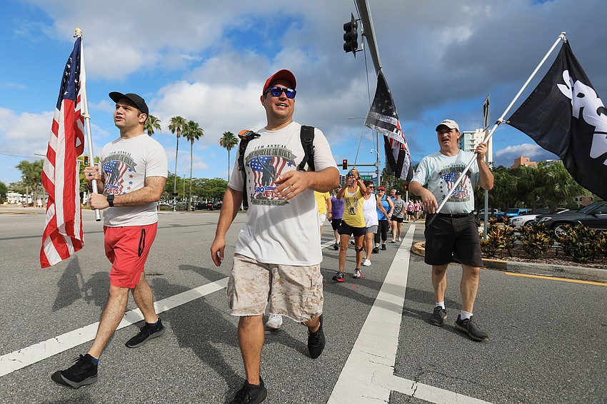 Mayor Erik Arroyo, SRQ Vets co-founder, SRQ Vets co-founder Bill Sterbinsky and others lead the march.
