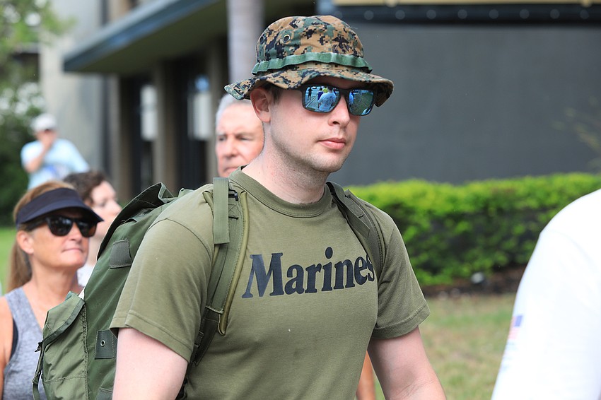 Davin Berry walks in Marine garb.