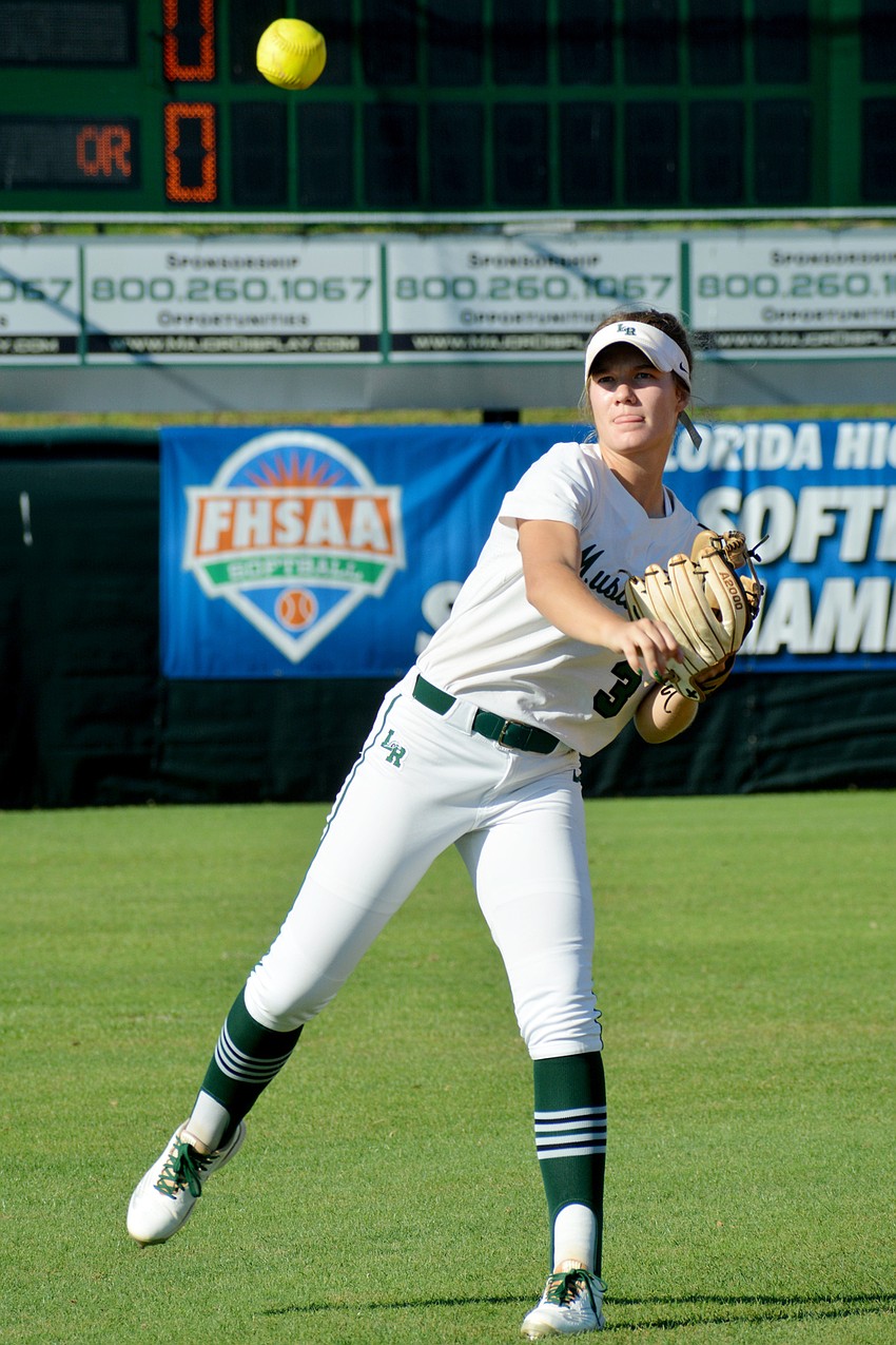 Lakewood Ranch junior Cassidy McLellan throws from the outfield between innings against Lake Brantley High.