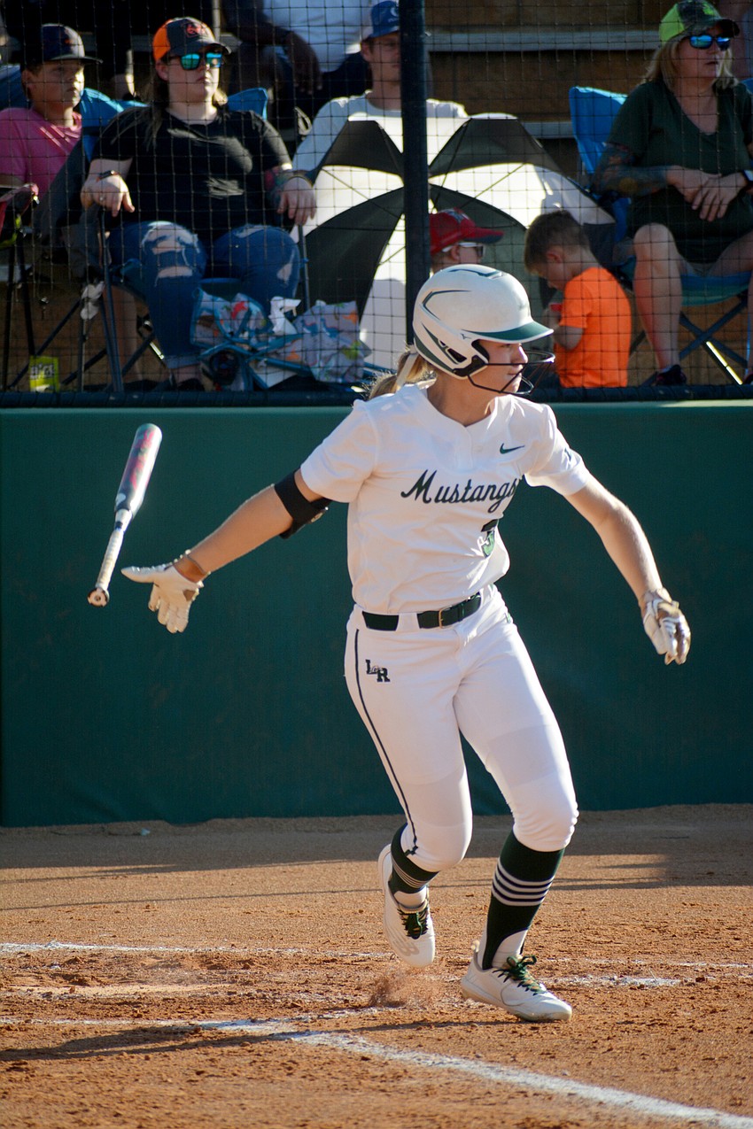 Lakewood Ranch High junior Cassidy McLellan tosses her bat after hitting a sharp ground ball against Lake Brantley High.