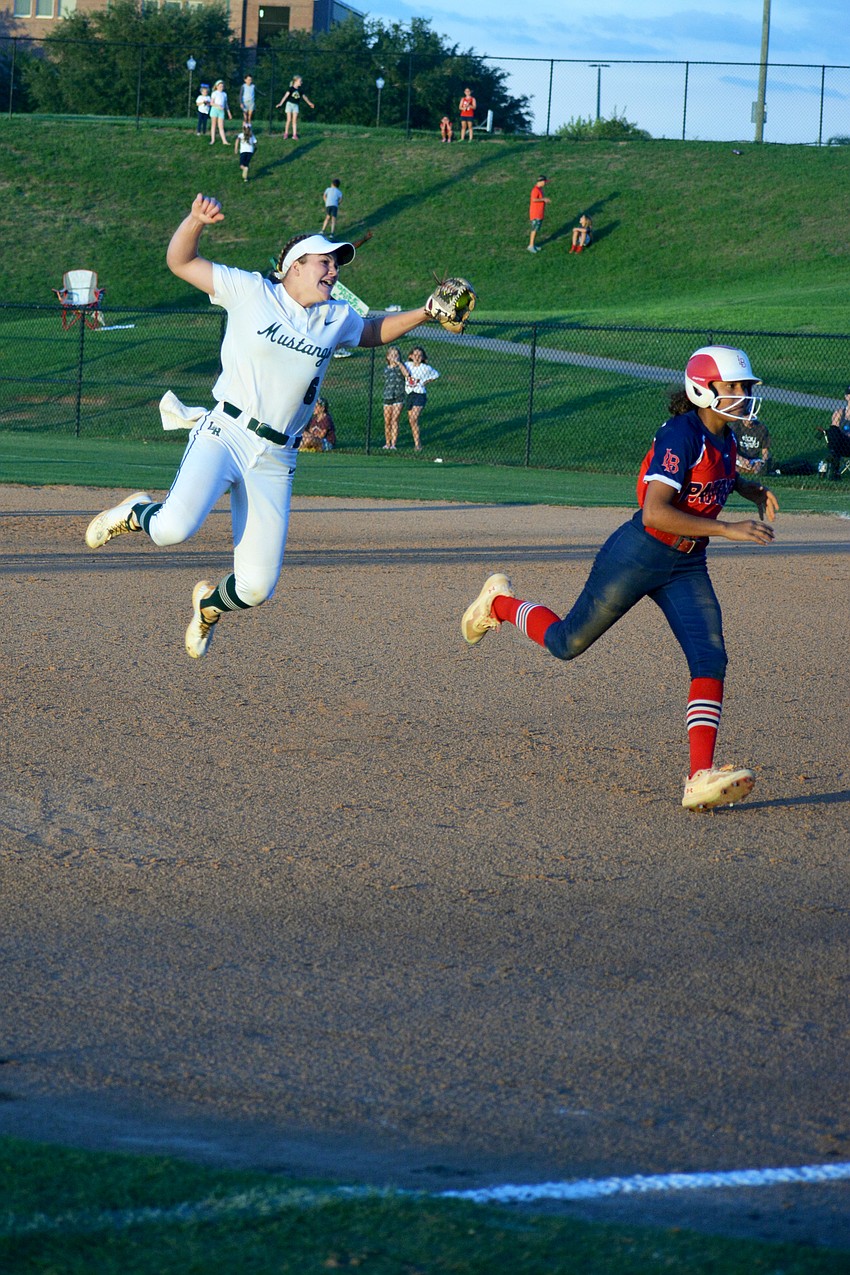 Lakewood Ranch High sophomore Ella Dodge jumps for joy after tagging out Lake Brantley High's Jaiden Griffith to end the game.