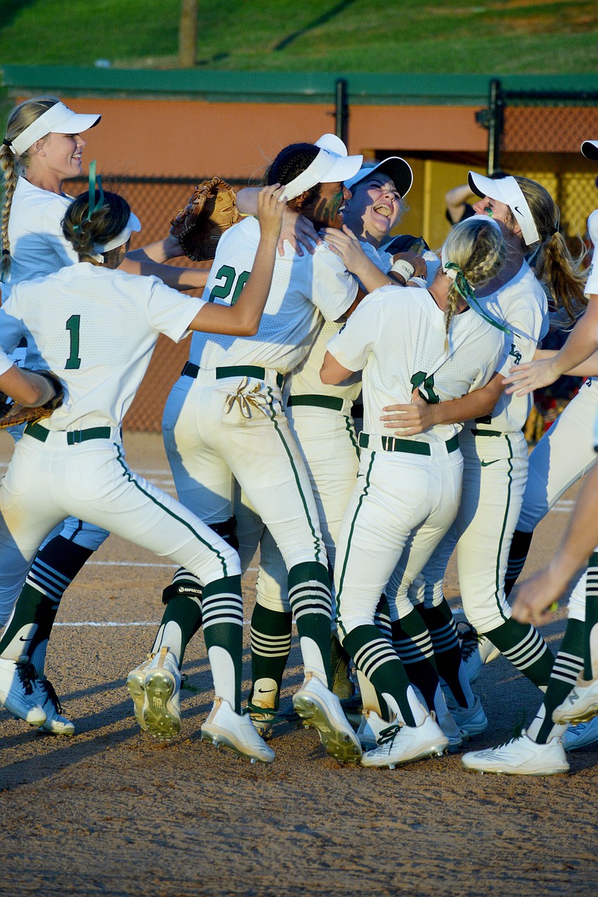 The Mustangs pile on sophomore Ella Dodge after defeating Lake Brantley High 8-2 to win their second straight Class 7A state championship.