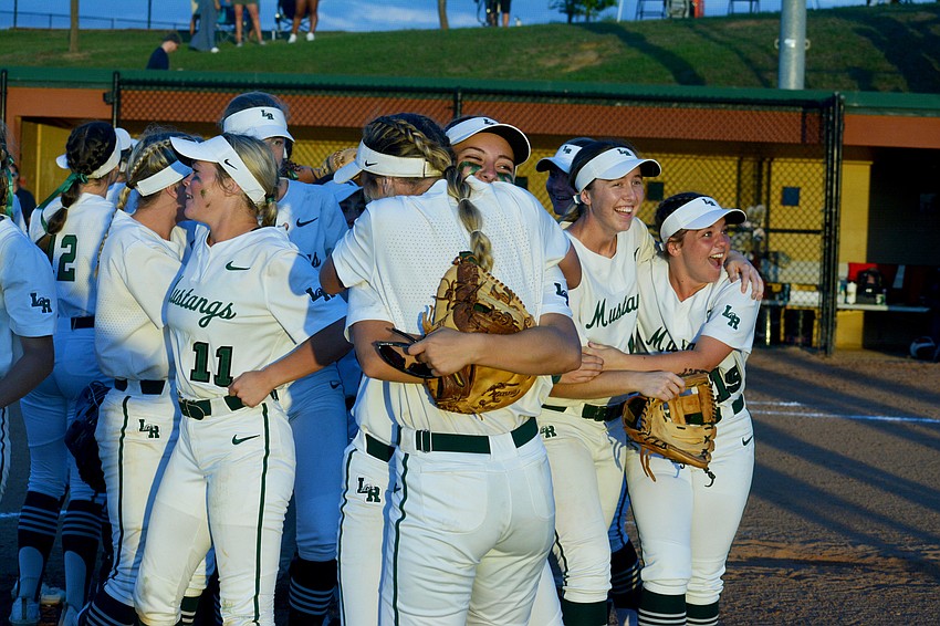 Lakewood Ranch High senior Taylor Shepherd hugs sophomore Grace Shaw-Rockey after the Mustangs beat Lake Brantley High 8-2 to win the Class 7A state championship.