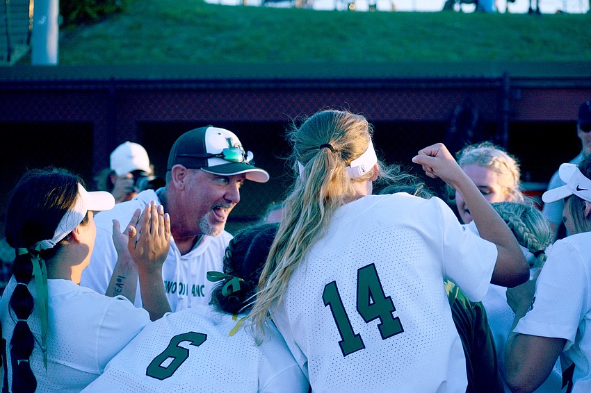 Lakewood Ranch High Coach T.J. Goelz brings his players together for a celebration after the Mustangs defeated Lake Brantley High 8-2 to win the Class 7A state championship.