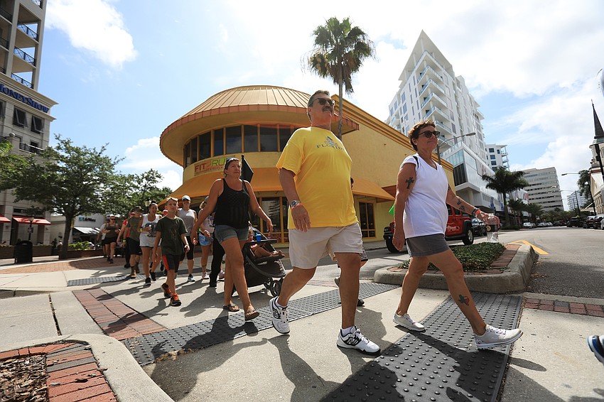 Veterans and civilians alike march through downtown Sarasota.