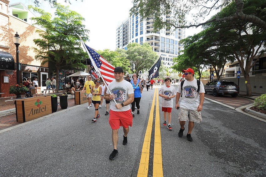 Mayor Erik Arroyo, SRQ Vets co-founder SRQ Vets co-founder Bill Sterbinsky and others lead the march.