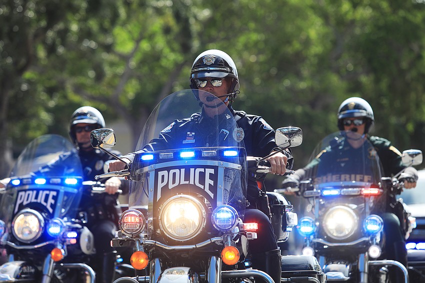 Police officers help lead the parade.