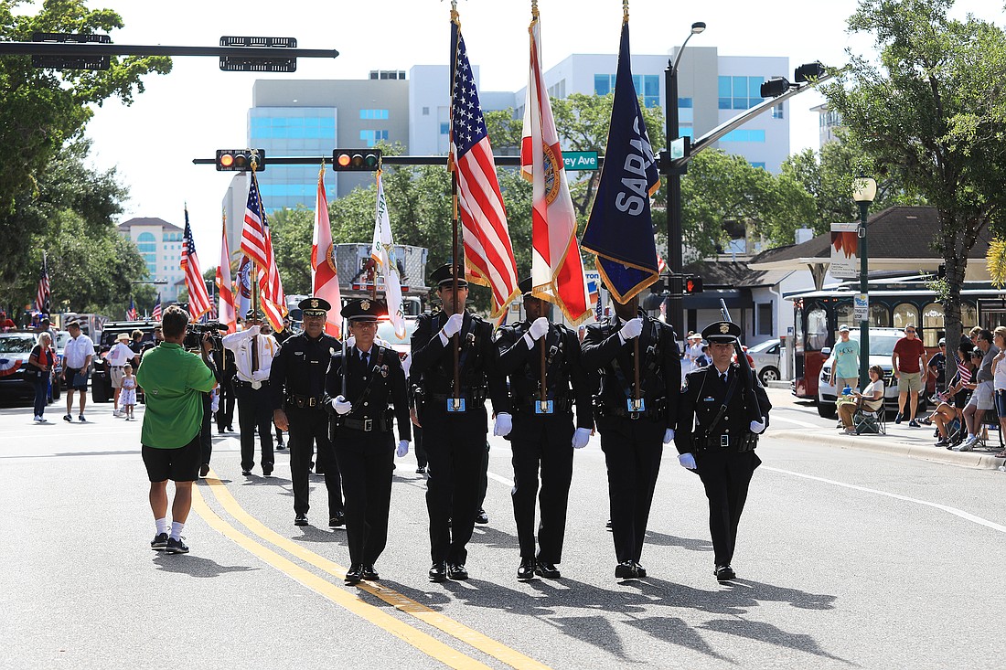 Police officers help lead the 2022 Memorial Day Parade.