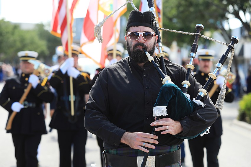 Micah Adams plays the pipes in the march.