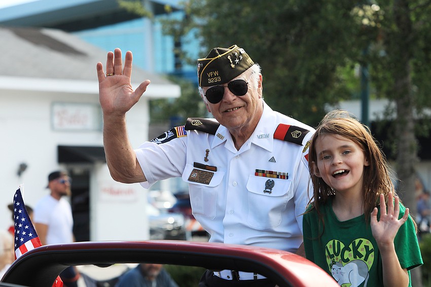 Pete Beisley and Keriana Carll ride along and wave to the crowd.