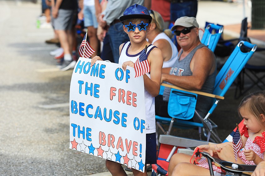 Brooks Roy brings his sign to the parade.