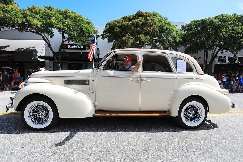 Sal Santoro waves from his vehicle.