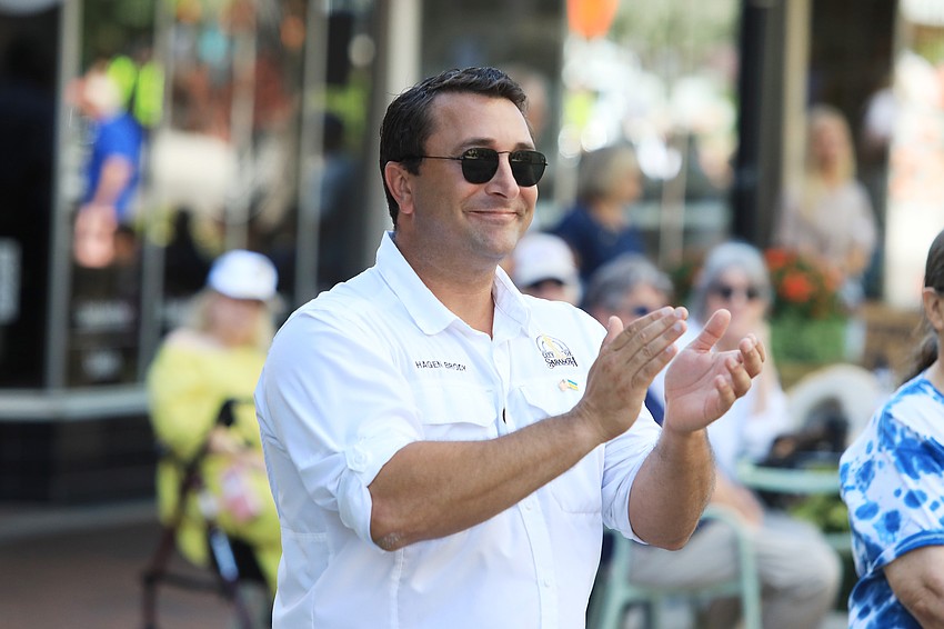 Commissioner Hagen Brody cheers on the vehicles.