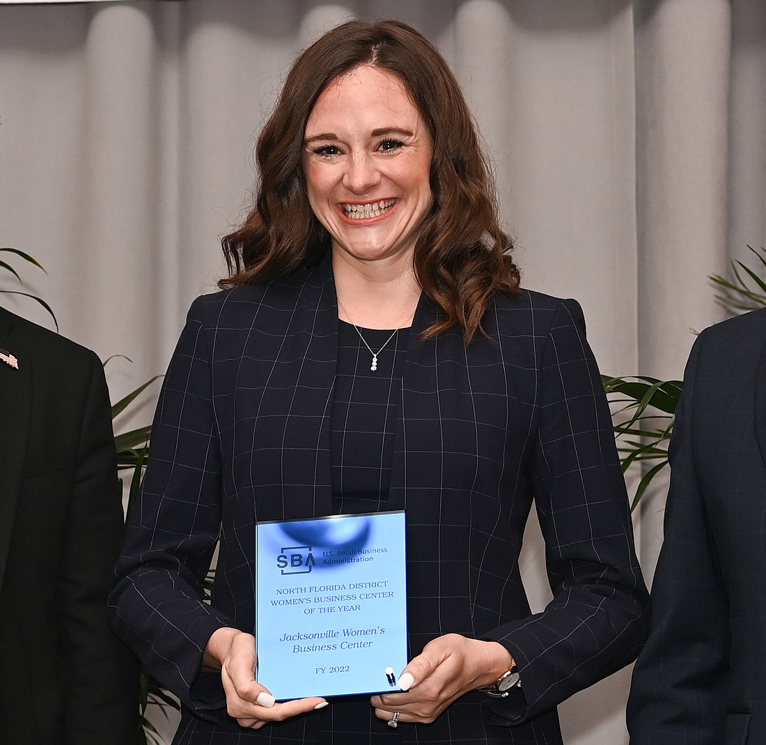 Jacksonville Womenâ€™s Business Center Director Jackie Perrault with her organizationâ€™s award.