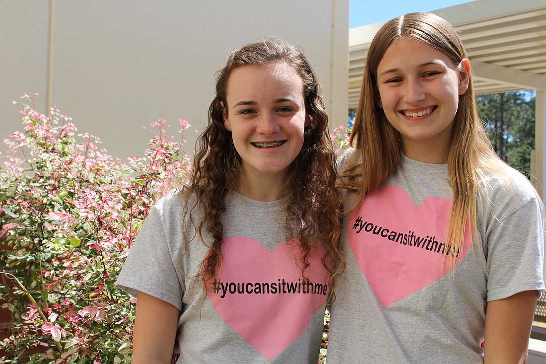 Mae-Elizabeth Vuncannon and Danielle Dupuis and are two eighth graders from Windy Ridge K-8 School who created a T-shirt initiative to make sure no one unwillingly sat alone at lunch again.
