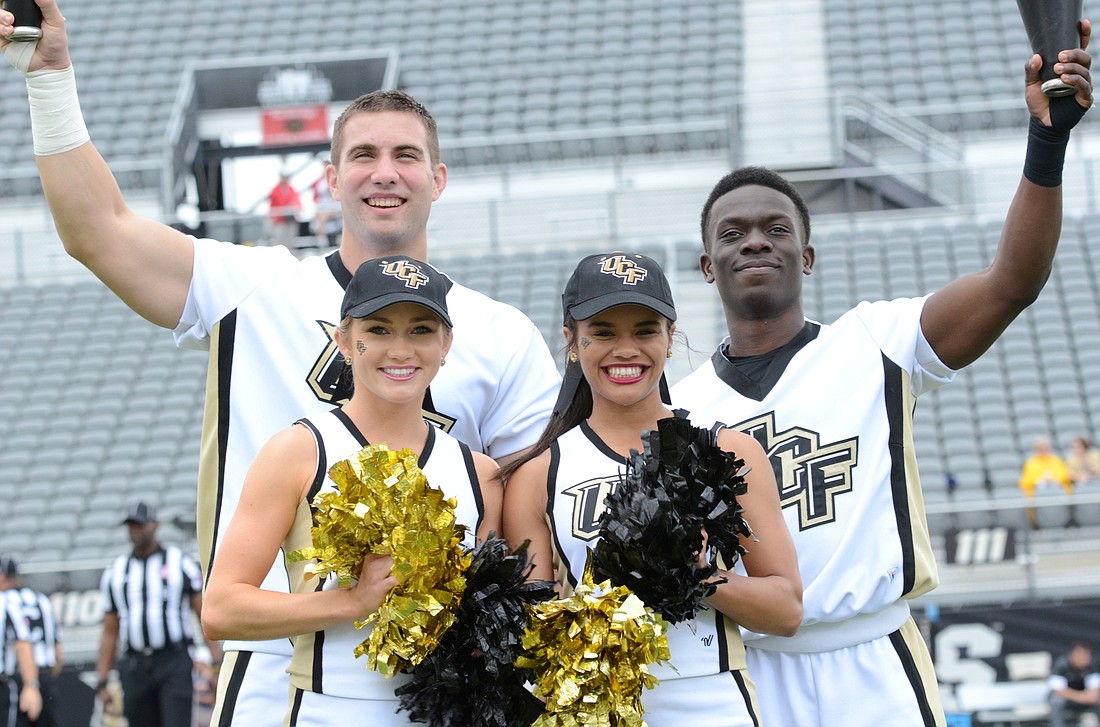 Sideline cheerleaders Alec Holland, left, Stephanie Hierholzer, Juliana Coipel and Miterson Charles â€” all local alumni â€” have kept the home crowd pumped up during UCFâ€™s breakout season on the football field.