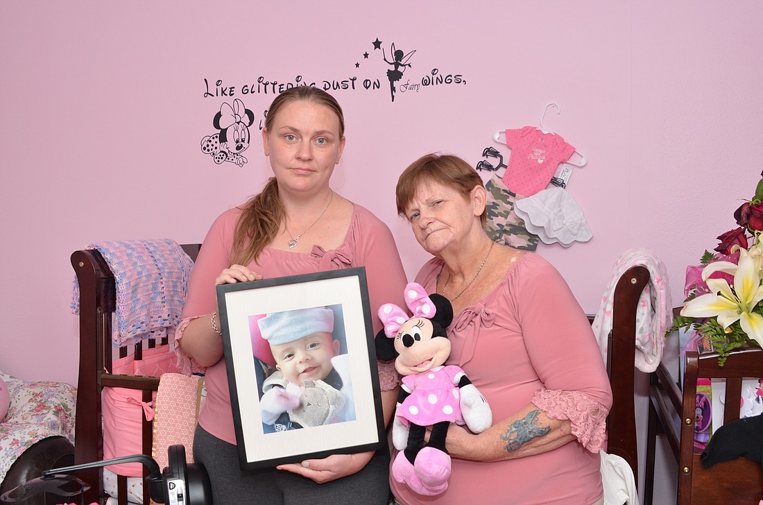 Tanya Murphy Estrada, left, and Debbie Murphy mourn the death of their daughter and granddaughter, Trinity, who passed away while the parents were tending to a family emergency in Georgia.