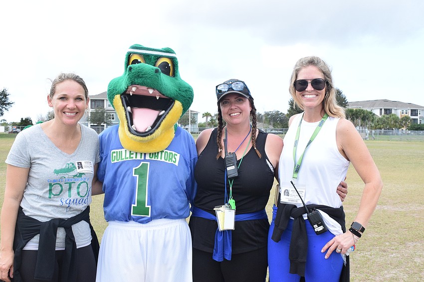 Parent-Teacher Organization Secretary Katie Truxton, Chompy, Vice President Julie Fitzpatrick and President Kristin Pomeroy enjoy seeing the students participate in the walkathon.