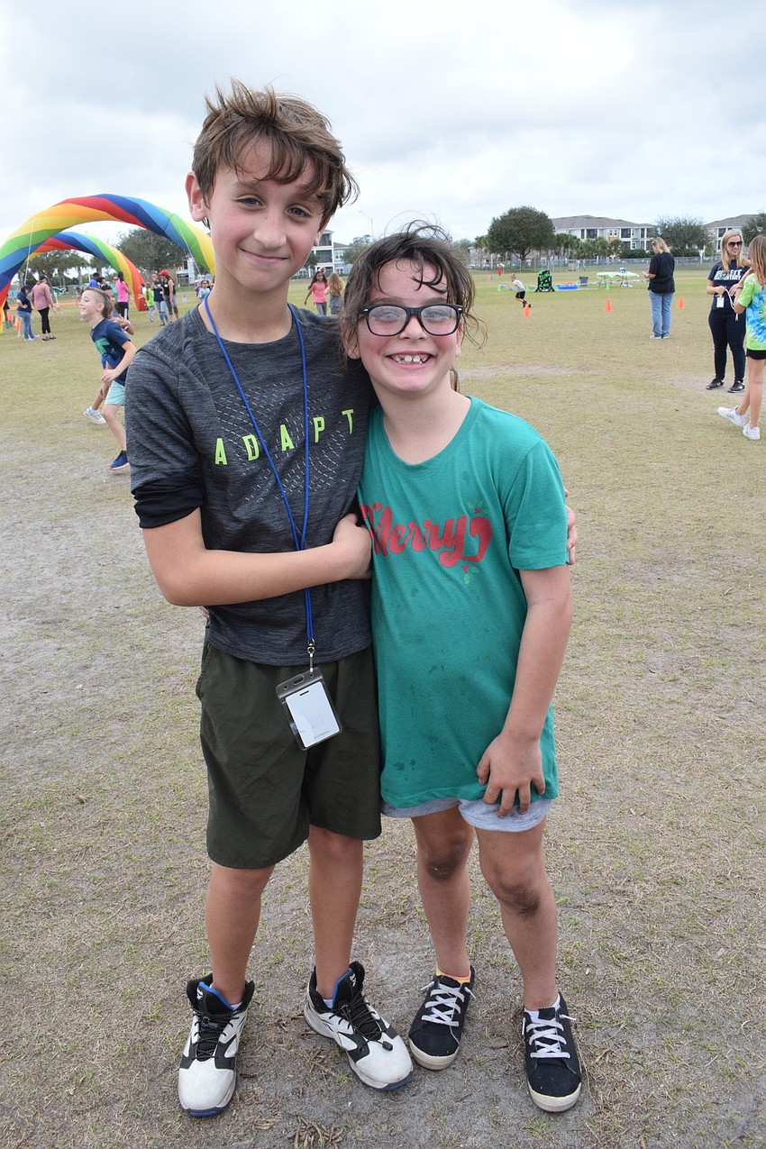 Third graders Jax Douglas and Lily Nisi love dancing with Chompy, the mascot of B.D. Gullett Elementary School.