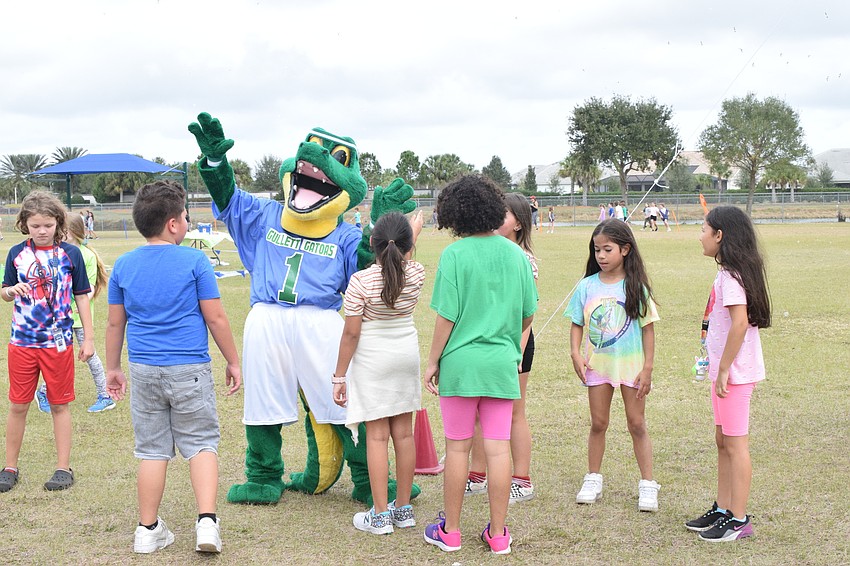 Third graders dance with Chompy, the mascot of B.D. Gullett Elementary School.
