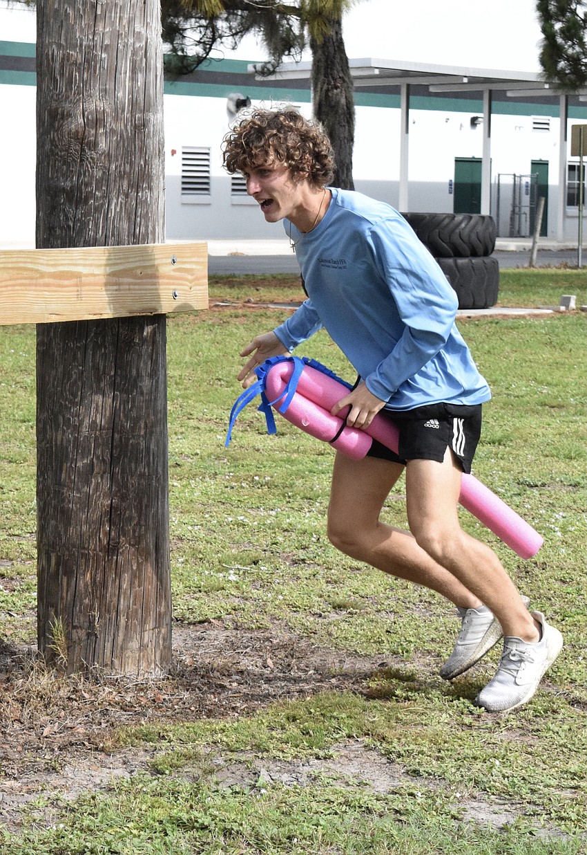 Noah Rueping, a rising junior, gallops as fast as he can around the posts.