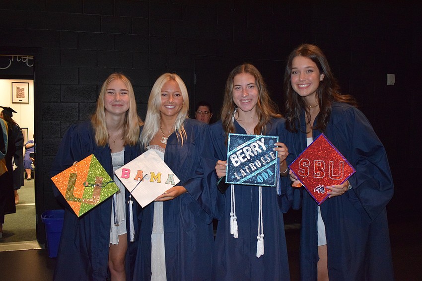 Alexandra Morgan, Ainsley Smith, Dani Taraska and Alyssa Romagnola decorate their caps to show what universities they are attending next school year.