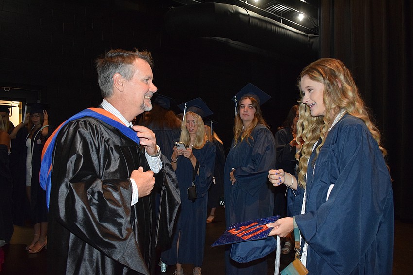 Sean Ball, the head of upper school, talks to graduate Brooke East, who plans to attend the University of Florida.