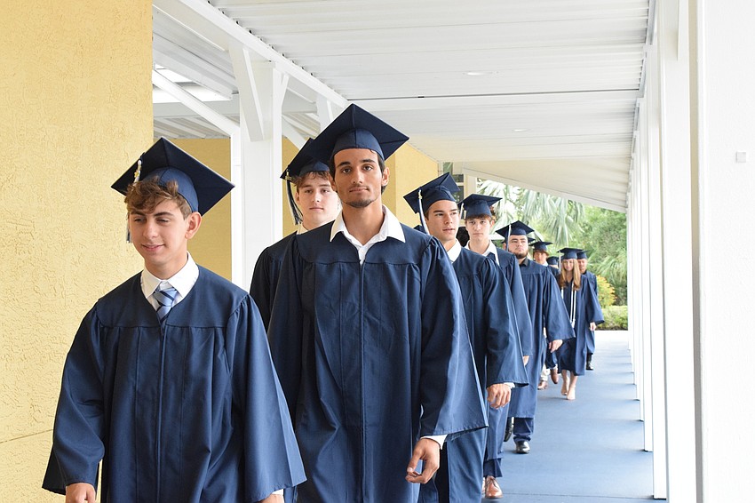 Graduates make their way to the Thunderdome for the graduation ceremony.