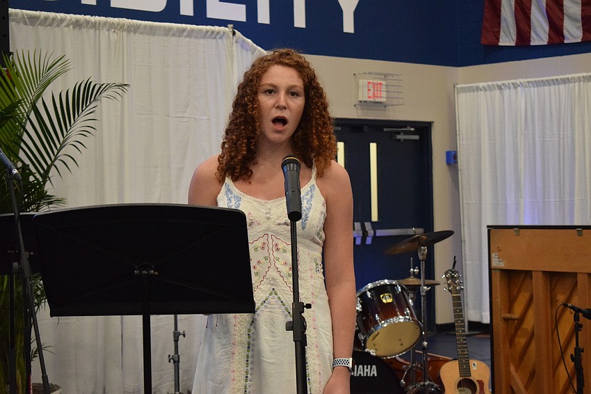 Junior Hannah Wahl sings Out-of-Door Academy's alma mater.