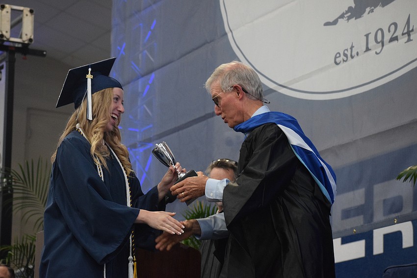 Ansley White accepts the Faculty Cup from James Connor, the interim head of school. The Faculty Cup honors the student who best exemplifies good character, scholarship, good spirit and has a positive influence.
