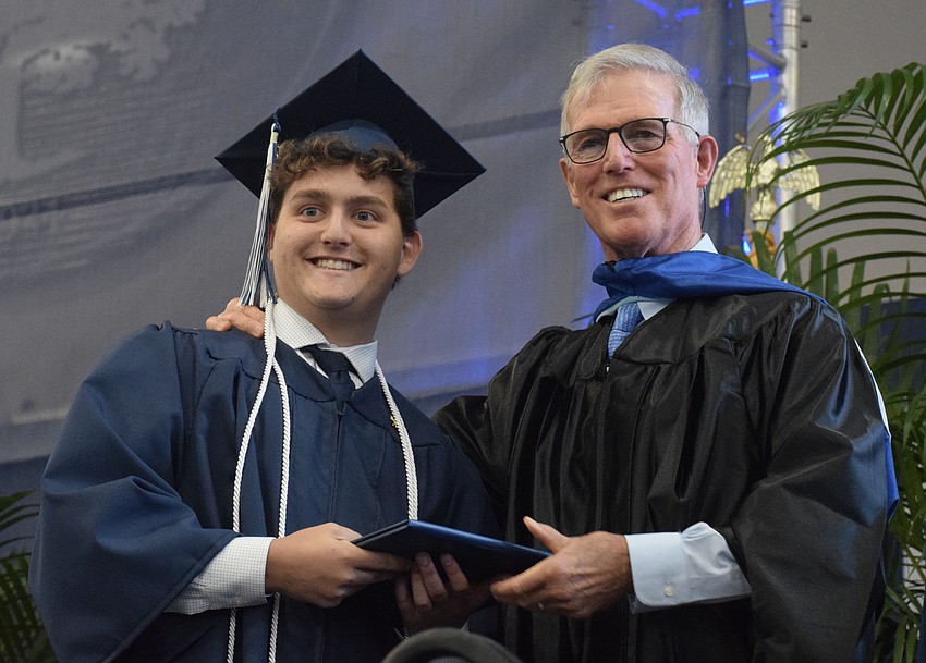 James Carrión accepts his diploma from James Connor, the interim head of school.