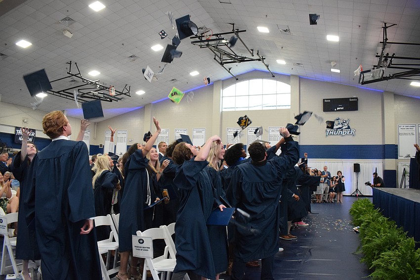 Graduates throw their caps in the air signifying their graduation from the Out-of-Door Academy.